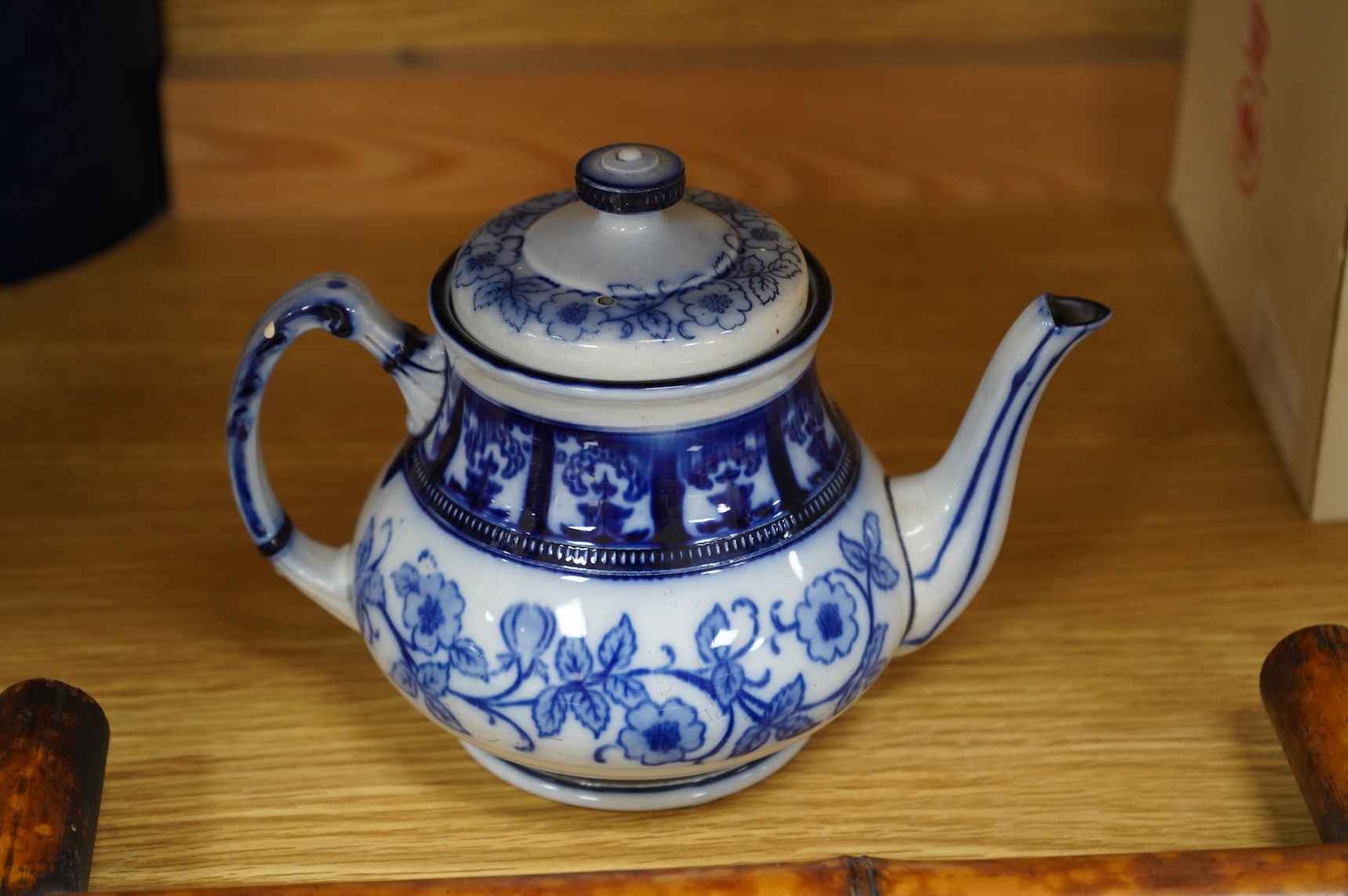 A MacIntyre Burslem blue and white teapot, c.1900, 15cm high and an early 20th century Chinese portrait photograph in a bamboo frame